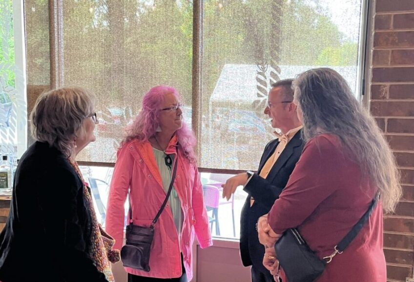 Chuck Taft talking to a few members of the Asheville Senior Chorus after a perfomance.