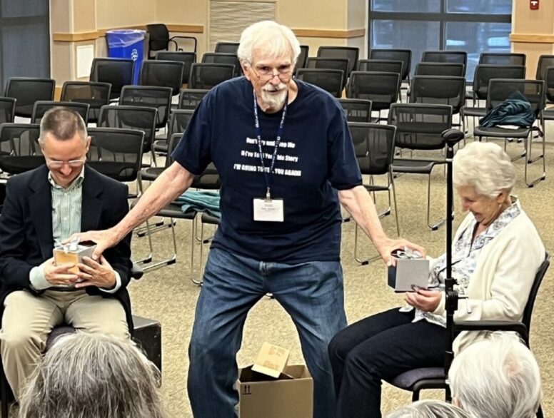 Chuck Taft and Nora Vetro receiving gift from the members of the Asheville Senior Chorus.