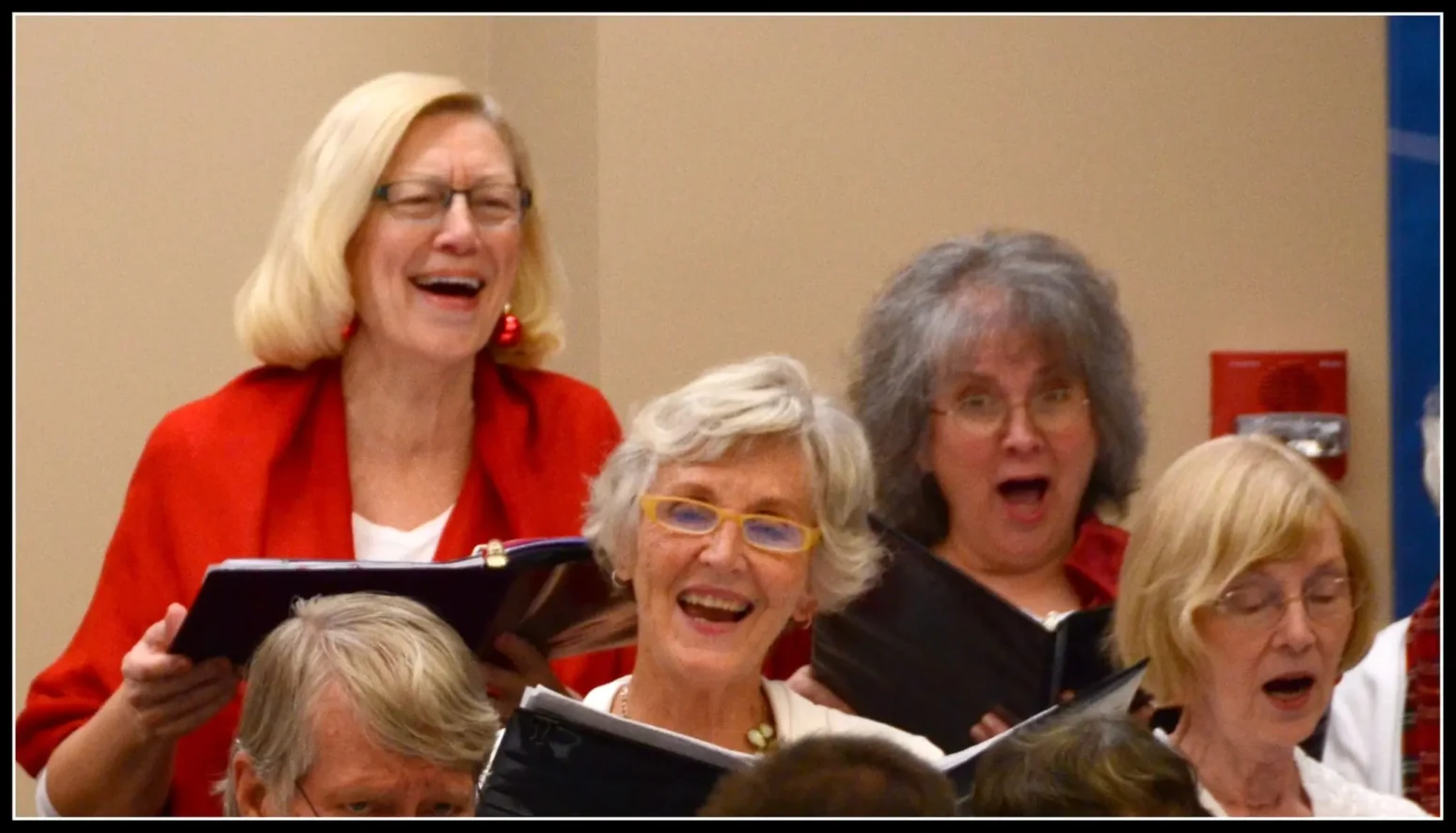 Ladies of the Asheville Senior Chorus sing happily in a holiday concert