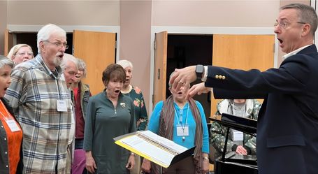 Music Director Chuck Taft conducting the Asheville Senior Chorus during a weekly rehearsal at OLLI UNC Asheville's Reuter Center.